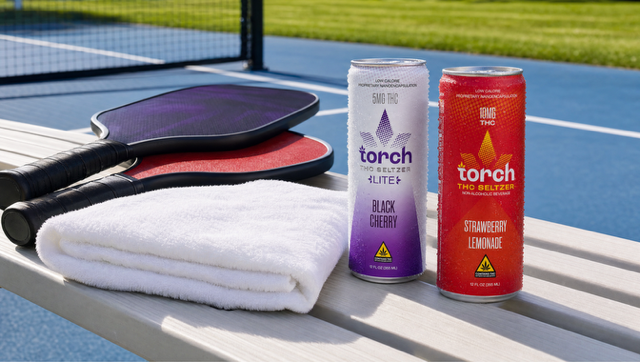 torch cans next to pickleball paddles as torch drinks begins their multi year sponsorship of major league pickleball